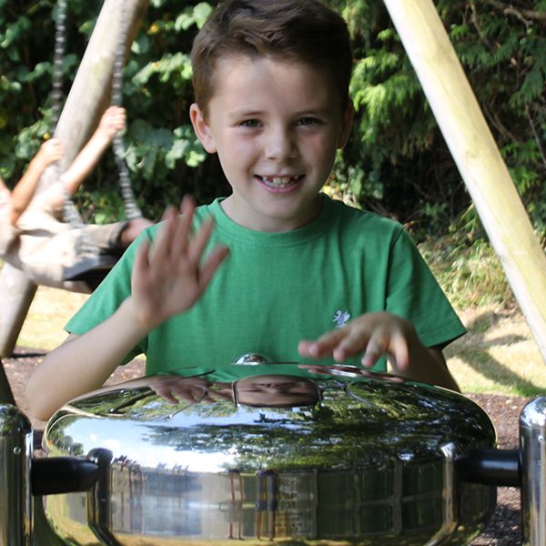 Boy Playing Stainless Steel Tongue Drum in Playground