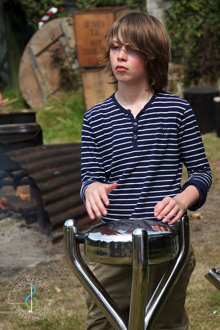 Teenage Boy Playing Stainless Steel Outdoor Tongue Drum