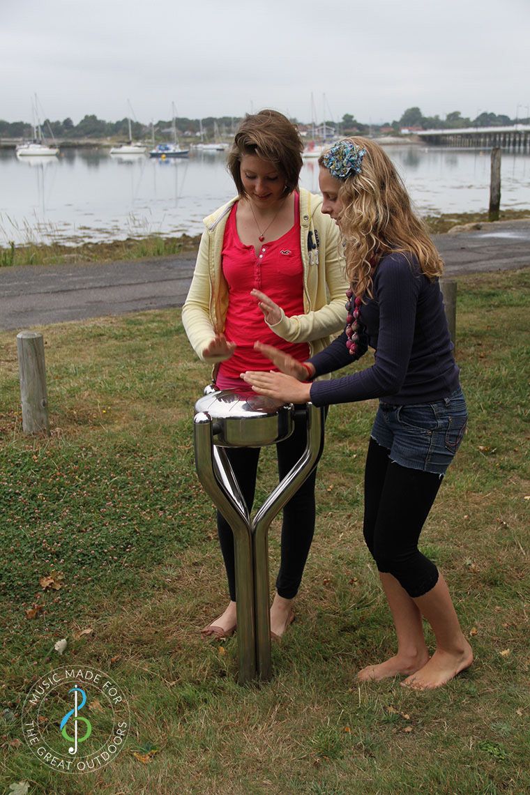 Tow Teenage Girls Playing Stainless Steel Tongue Drum by the Sea