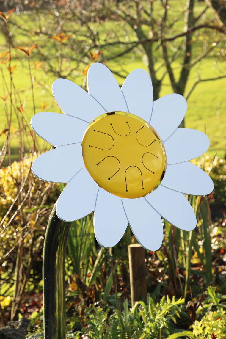 an outdoor musical drum in the shape and colours of a daisy