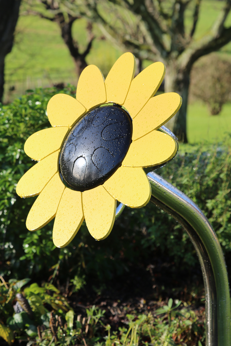 an outdoor musical drum in the shape and colours of a sunflower