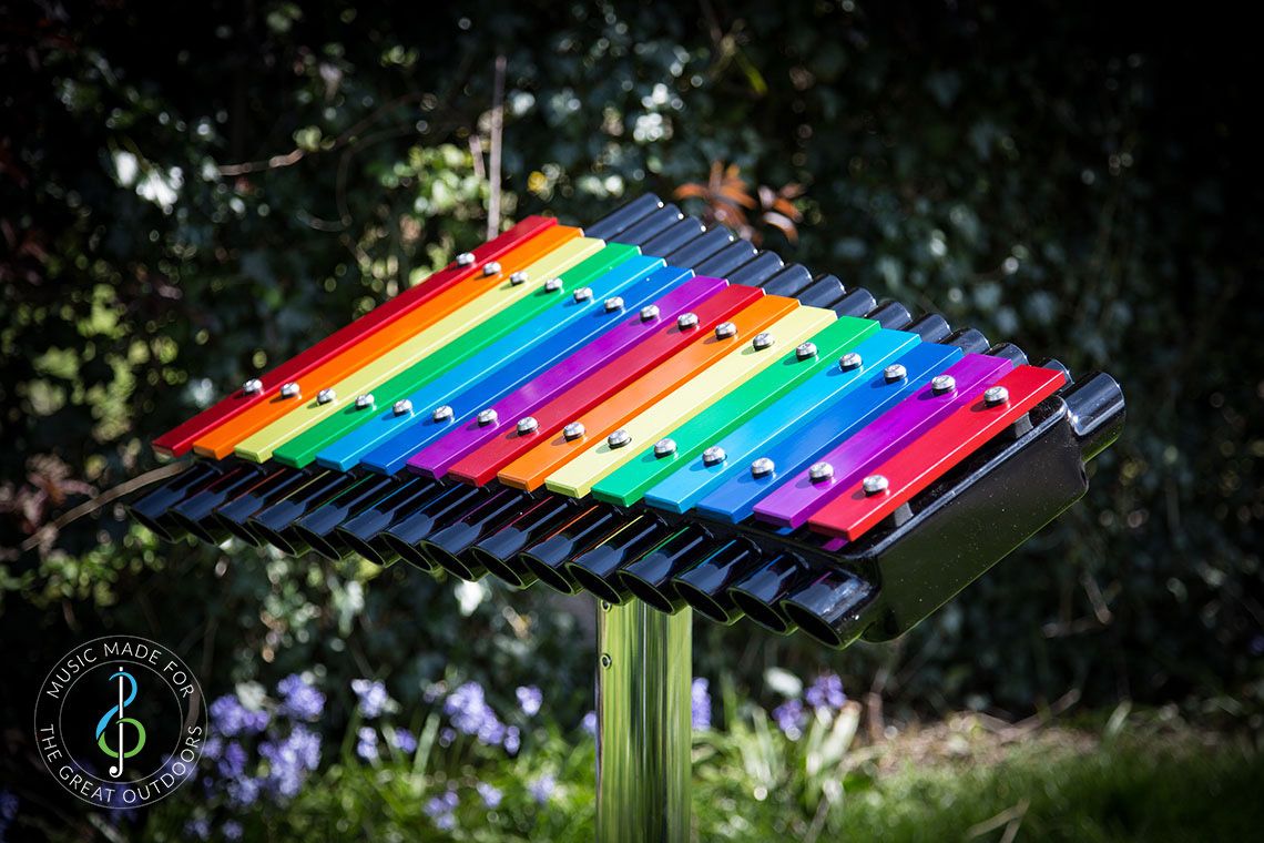 Large Xylophone with Rainbow Coloured Notes Outdoors in the sun