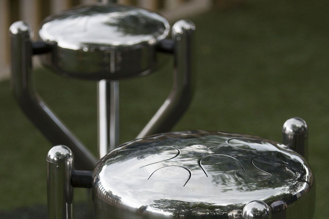 Two stainless steel tongue drums installed in a playground
